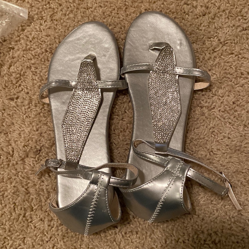 Silver sandals with ankle straps and rhinestones